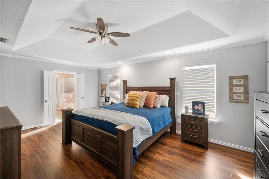 100 Ruth Court Aledo, TX 76008 - Photo 26 of 40 a bedroom with a bed and wooden floor