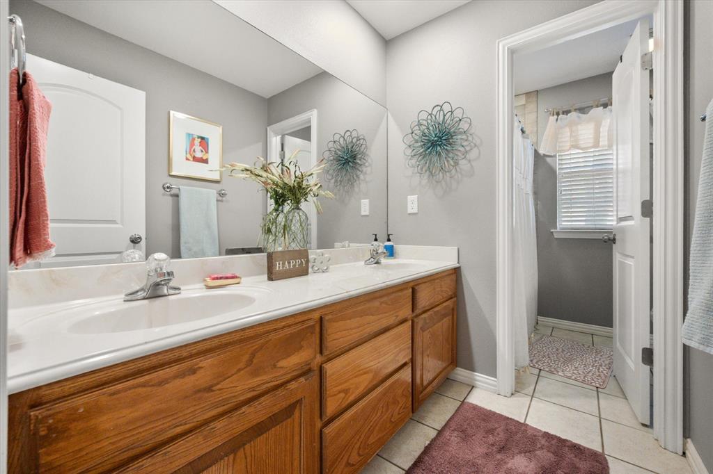100 Ruth Court Aledo, TX 76008 - Photo 32 of 40 a bathroom with a double vanity sink and mirror