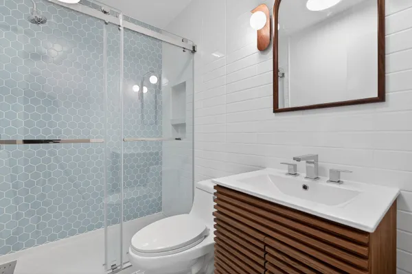 a bathroom with a sink toilet and shower