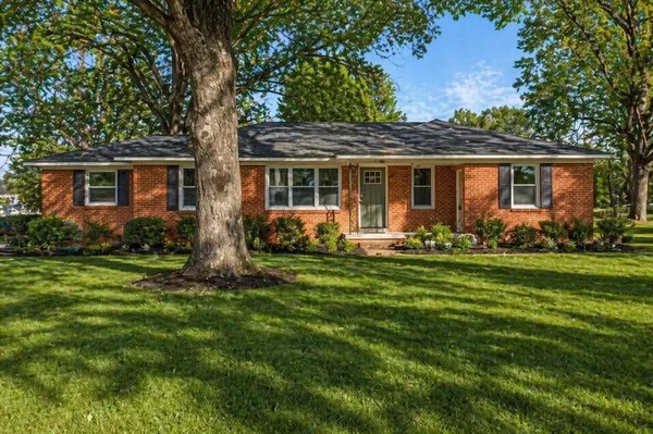 a front view of house with yard and green space