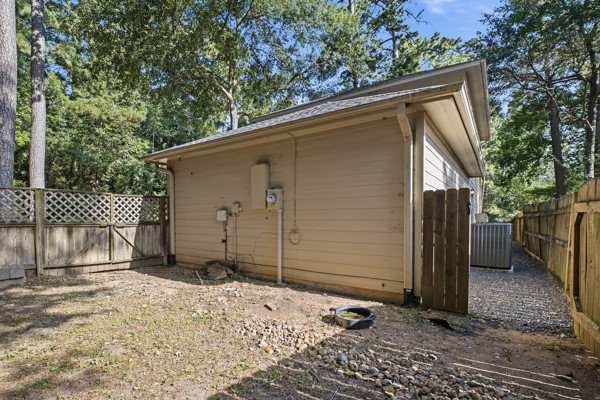 13396 Teel Road Montgomery, TX 77356 - Photo 42 of 50 a backyard of a house with a large tree and wooden fence