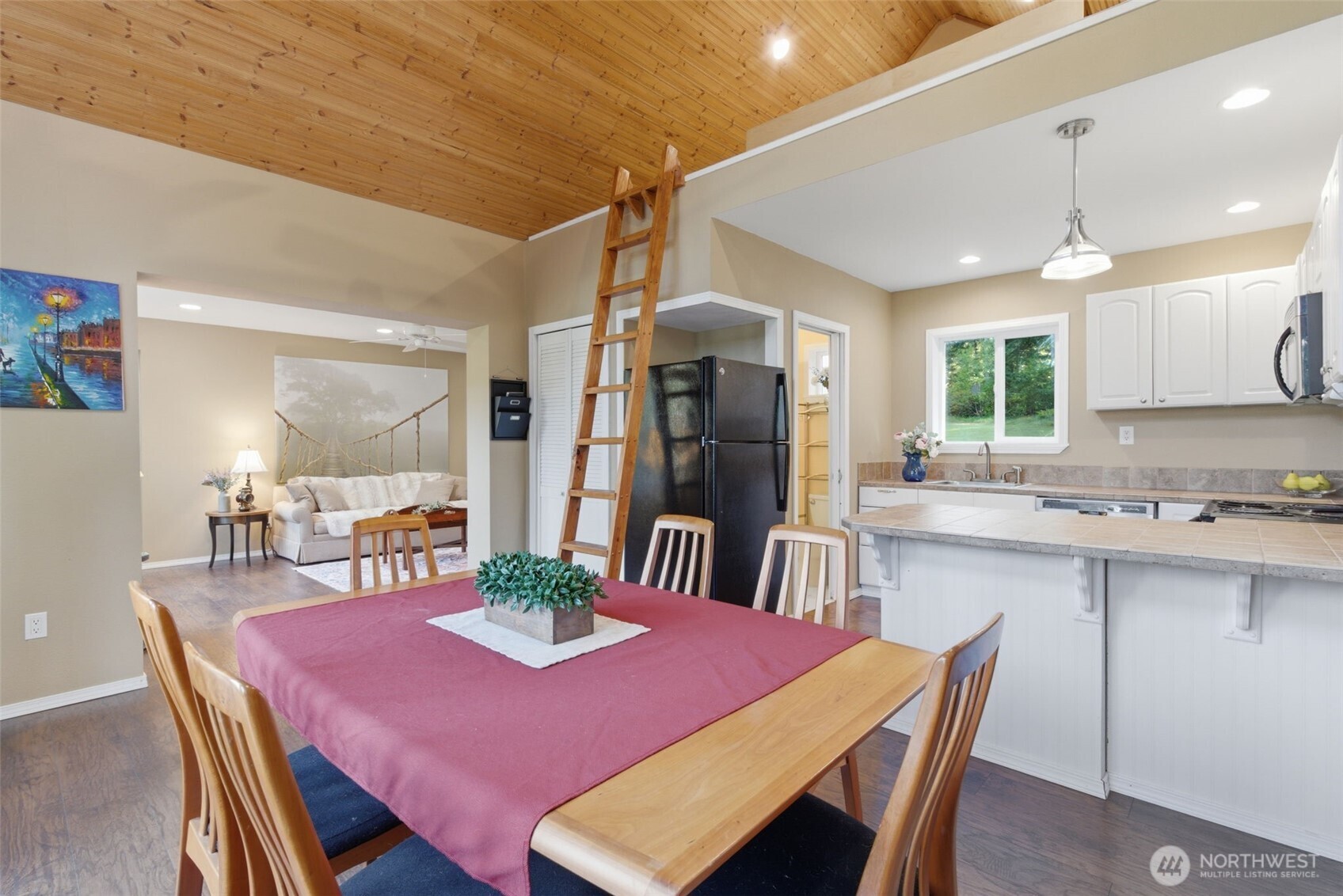 6971 Northeast Tahuya Blacksmith Road Belfair, WA 98528 - Photo 18 of 38 a dining room with a table chairs and kitchen view