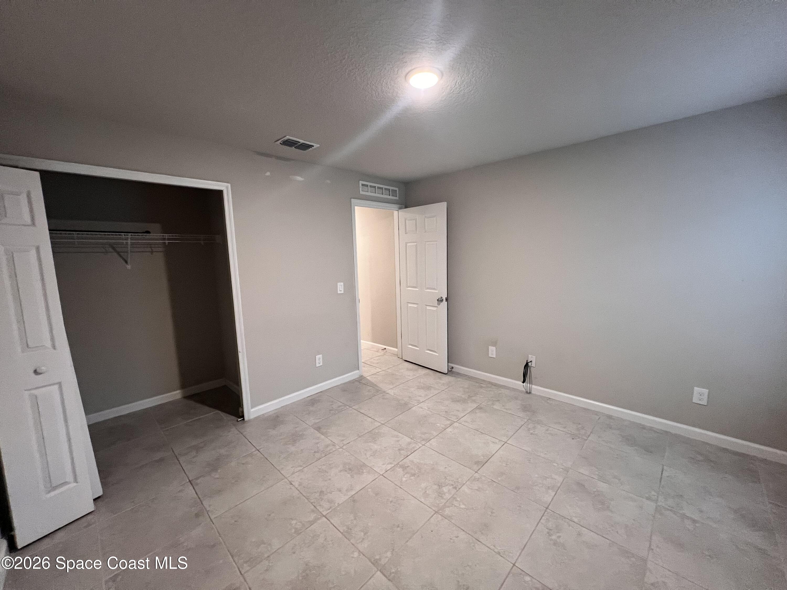 545 Cooper Court Palm Bay, FL 32908 - Photo 11 of 19 an empty room with windows