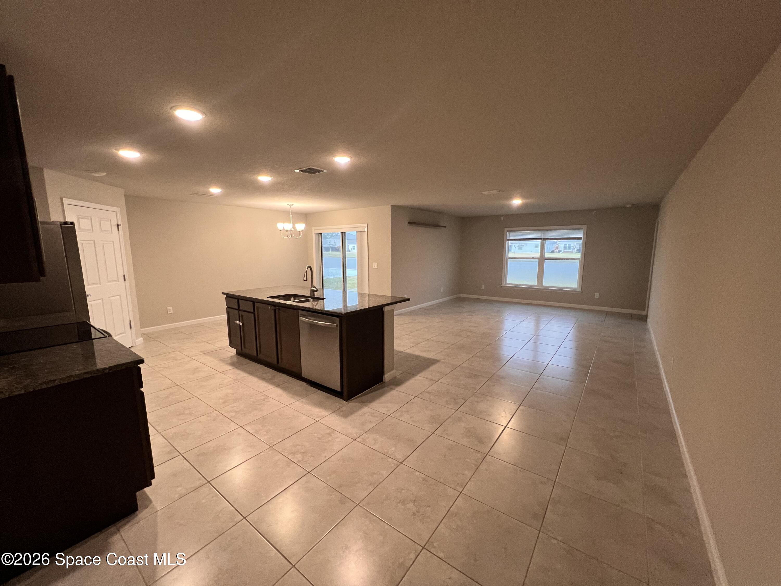 545 Cooper Court Palm Bay, FL 32908 - Photo 12 of 19 a view of a kitchen with a sink and a window