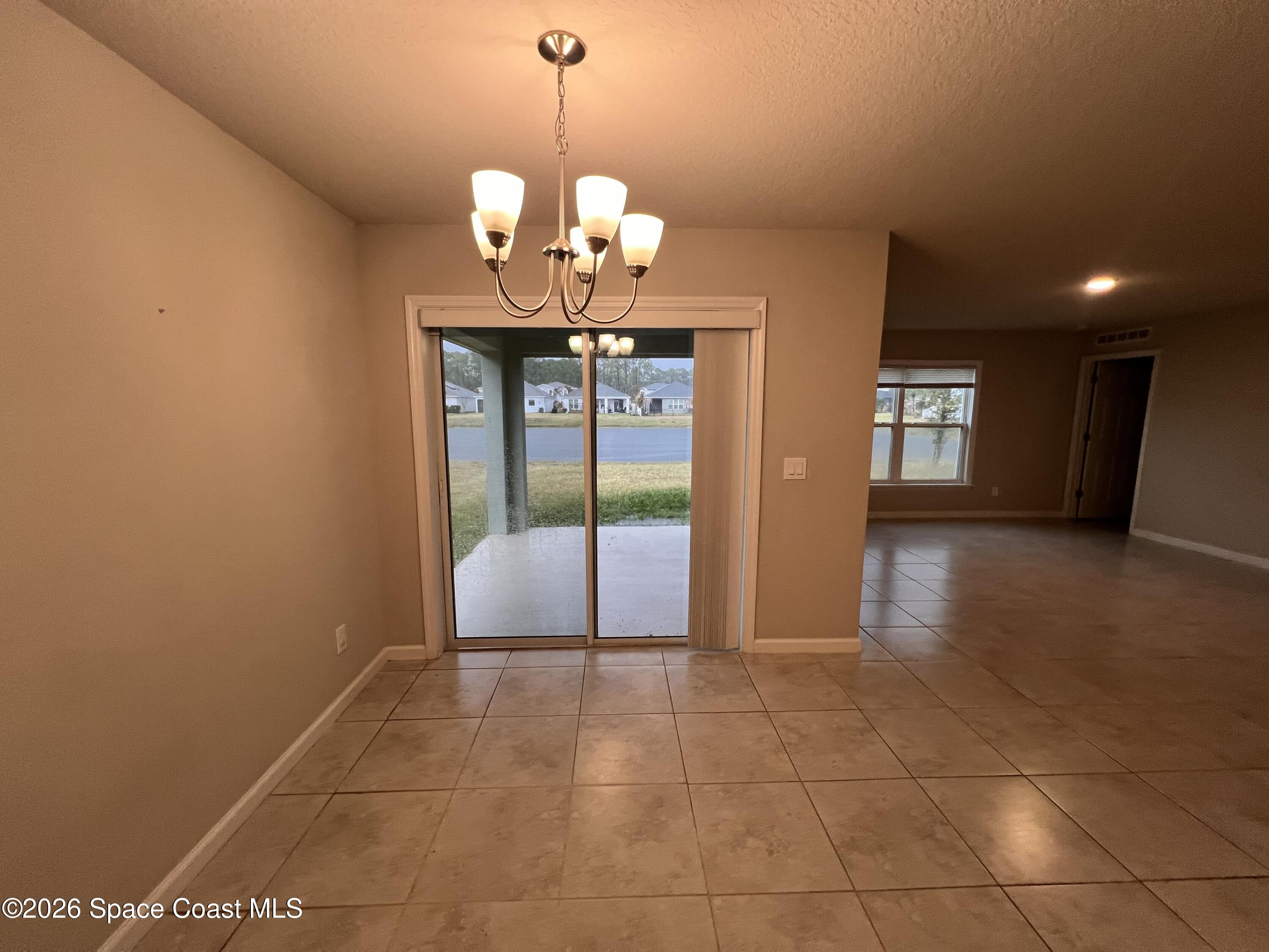 545 Cooper Court Palm Bay, FL 32908 - Photo 16 of 19 a view of a livingroom with a chandelier