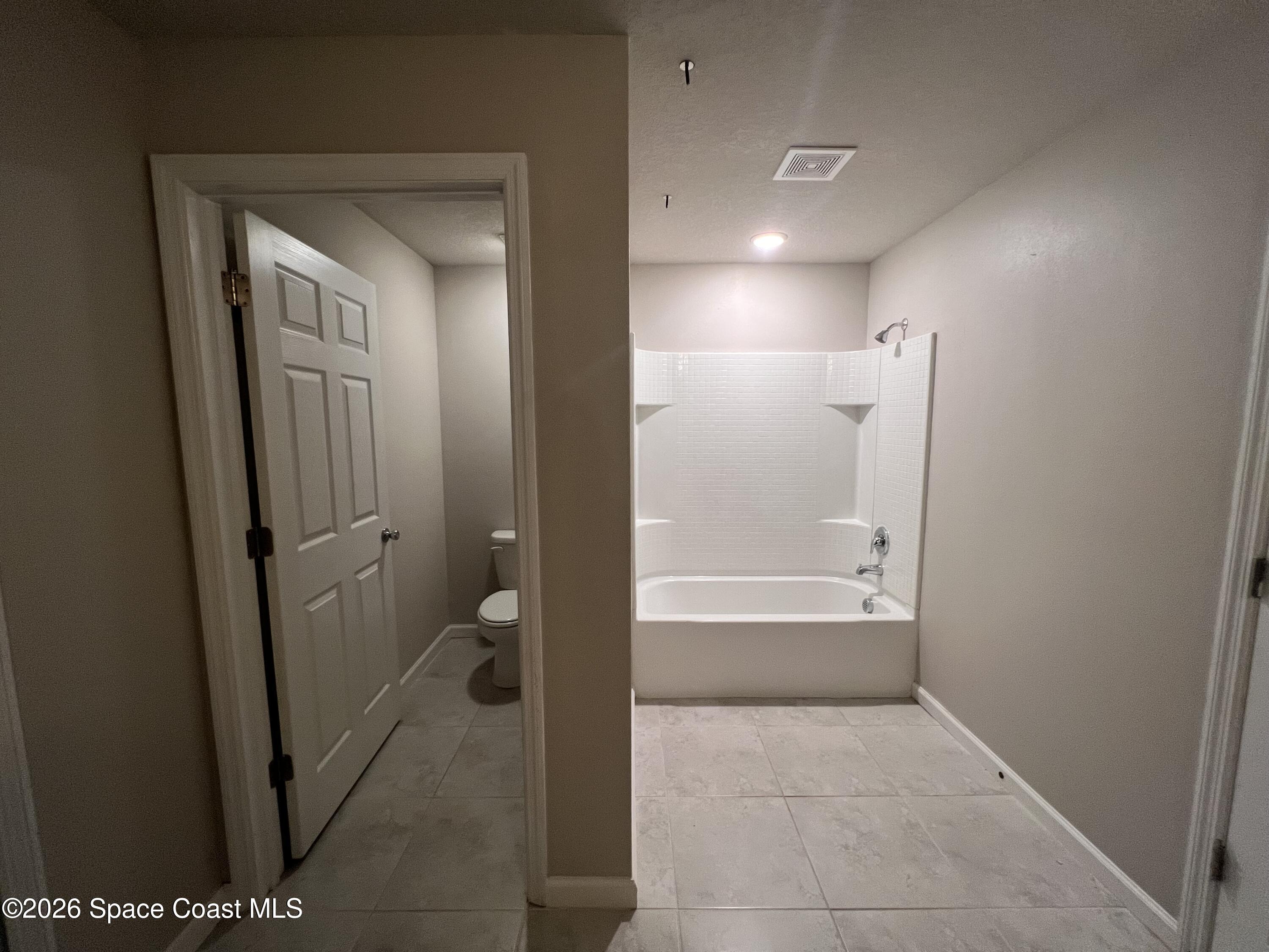 545 Cooper Court Palm Bay, FL 32908 - Photo 18 of 19 a bathroom with a bathtub and a shower