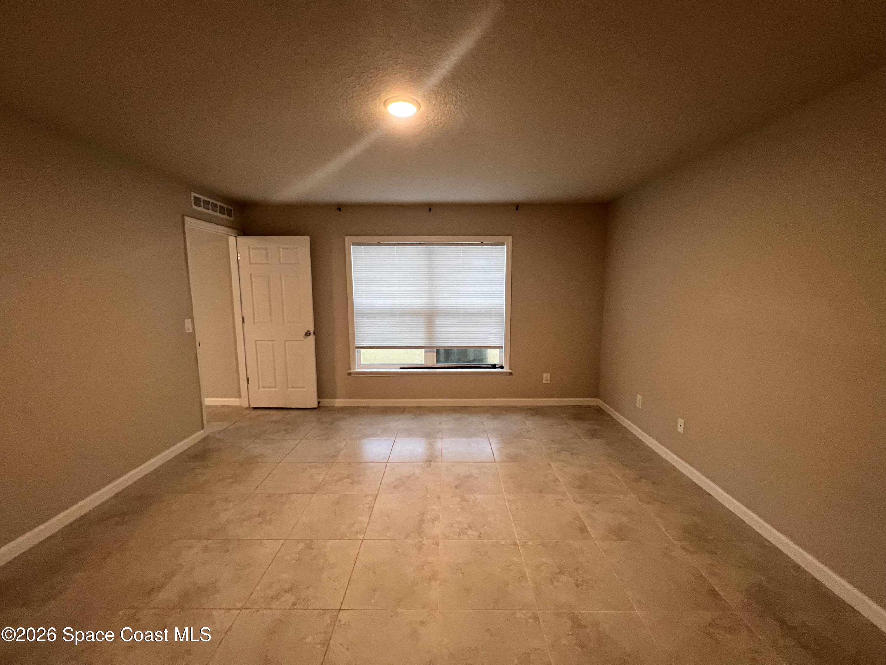 545 Cooper Court Palm Bay, FL 32908 - Photo 19 of 19 a view of an empty room with a window