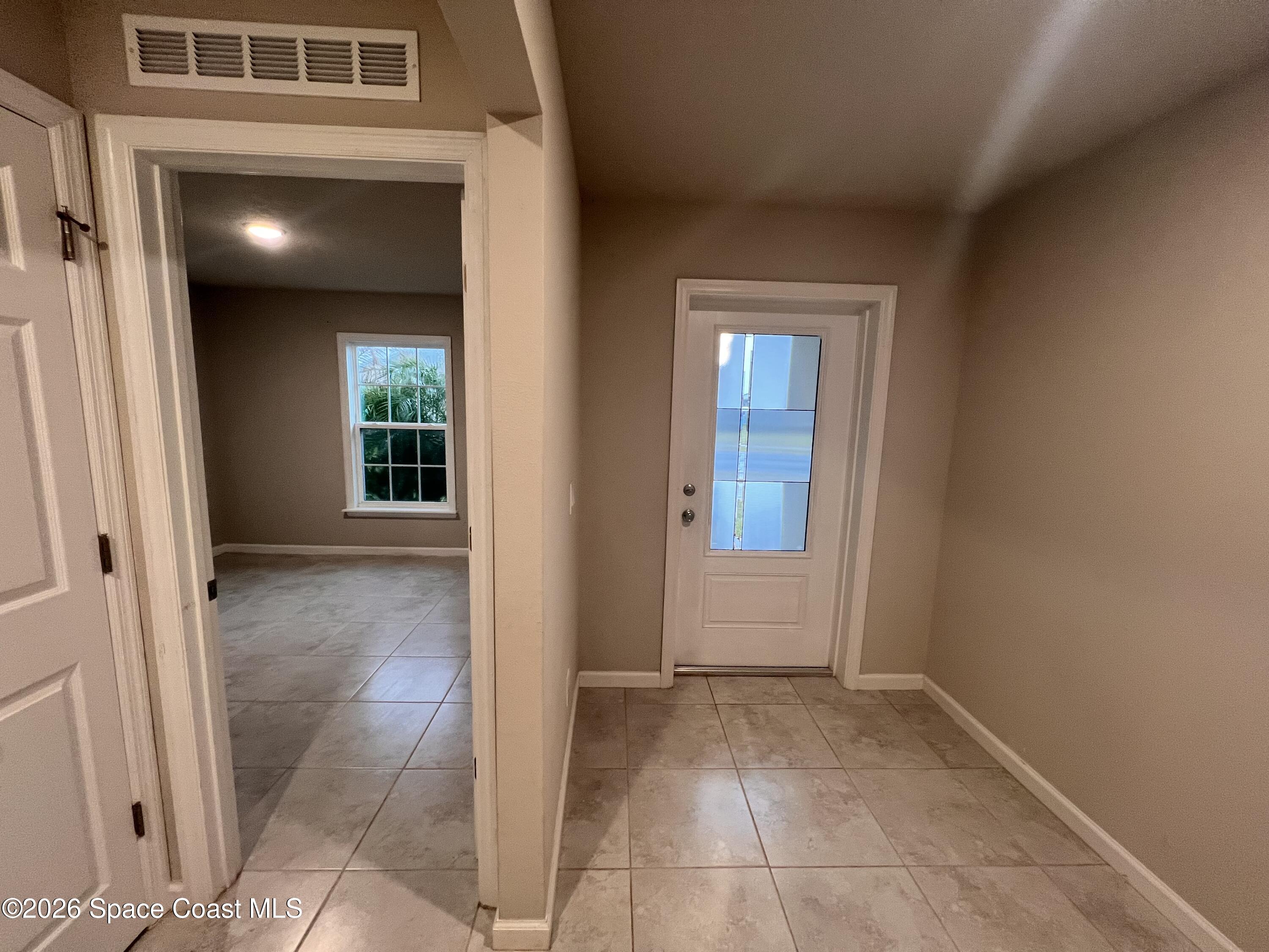 545 Cooper Court Palm Bay, FL 32908 - Photo 2 of 19 an entryway of a house and livingroom with furniture