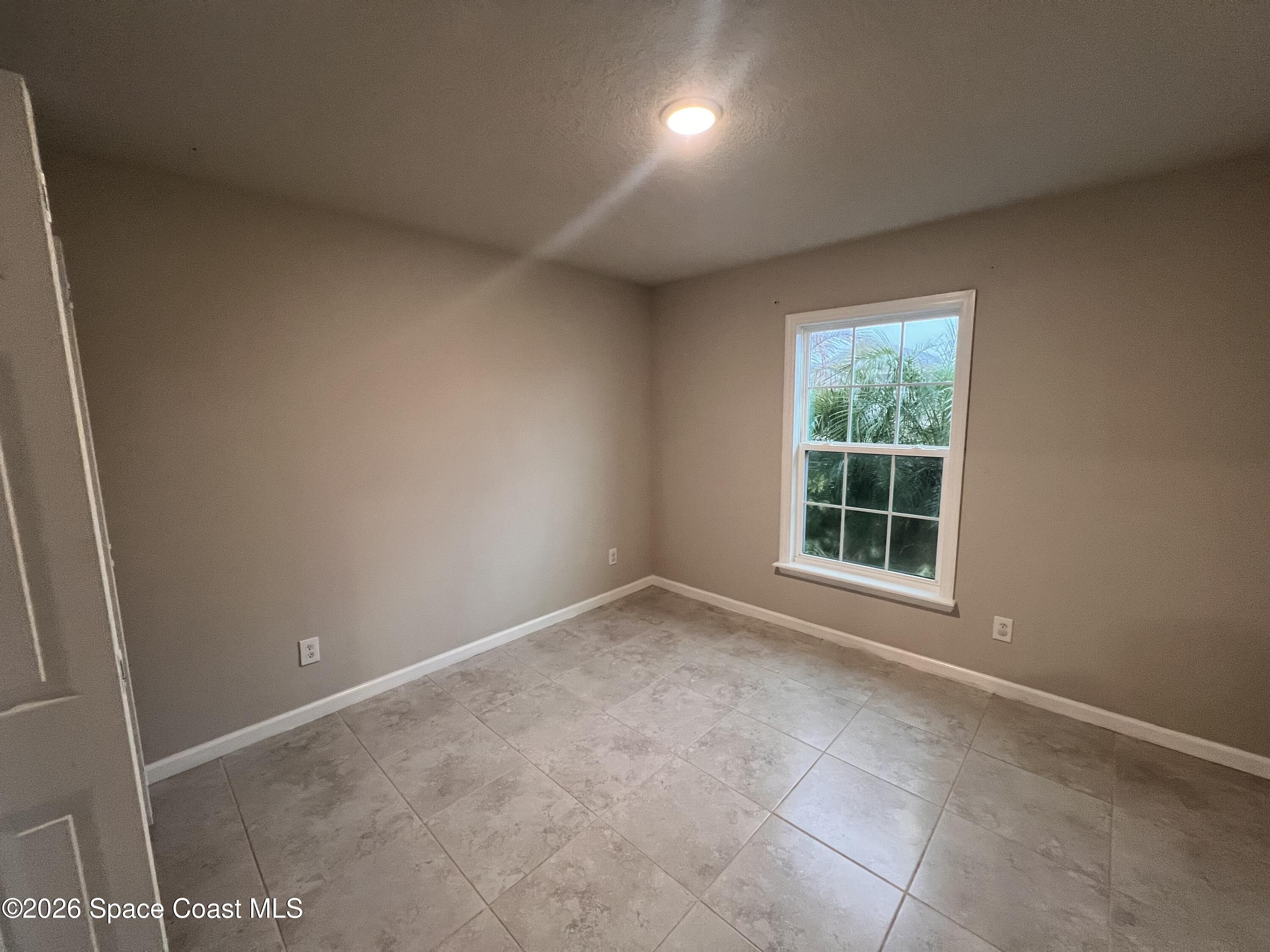 545 Cooper Court Palm Bay, FL 32908 - Photo 3 of 19 an empty room with a window