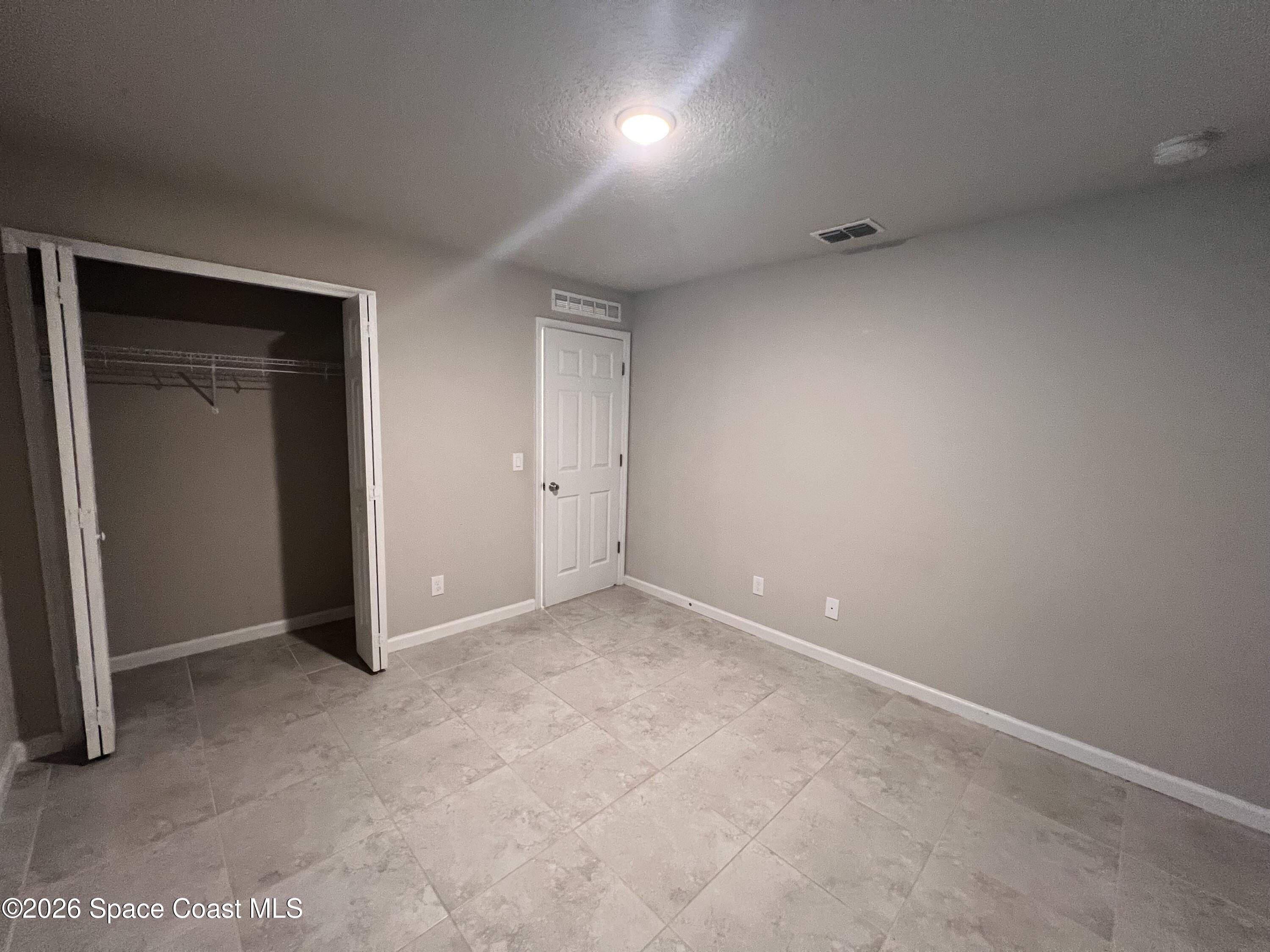 545 Cooper Court Palm Bay, FL 32908 - Photo 7 of 19 an empty room with an entryway