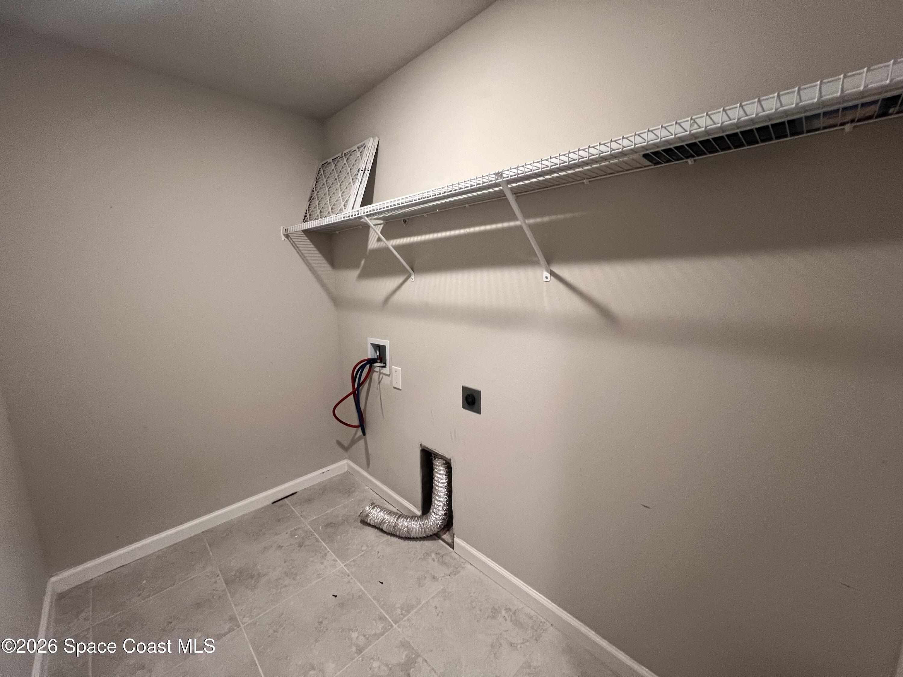545 Cooper Court Palm Bay, FL 32908 - Photo 9 of 19 a view of a room with racks on the wall