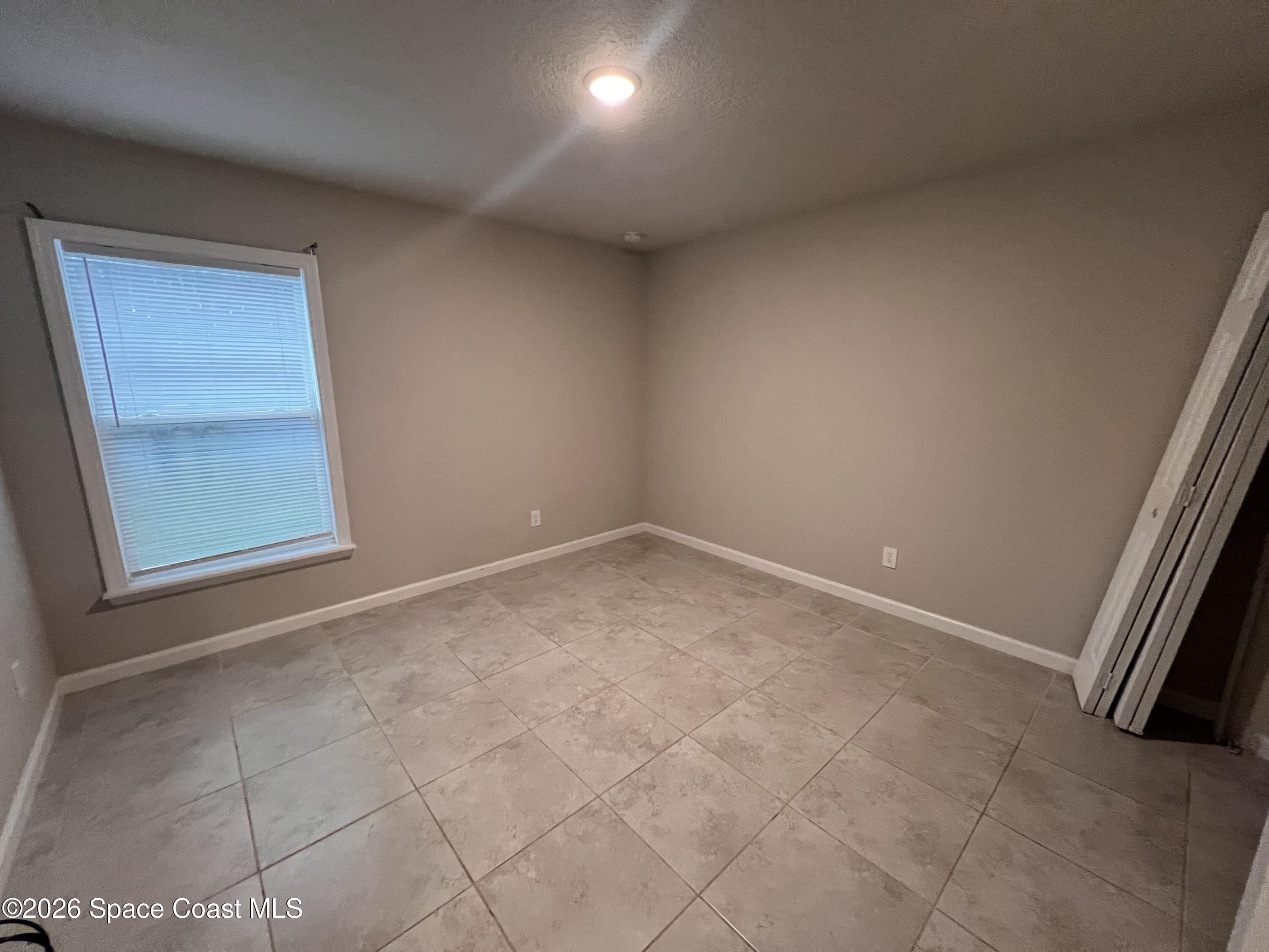 545 Cooper Court Palm Bay, FL 32908 - Photo 10 of 19 an empty room with windows