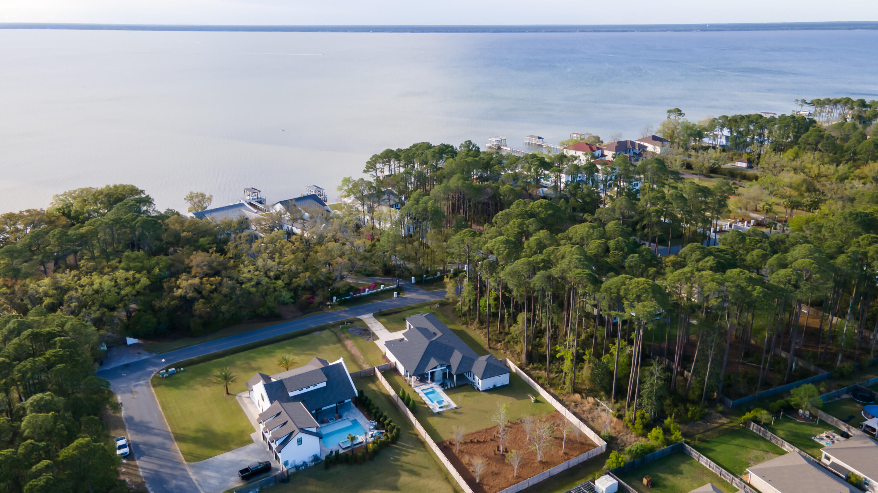 334 Driftwood Point Road Santa Rosa Beach, FL 32459 - Photo 2 of 50 a view of a backyard with plants and a lake view
