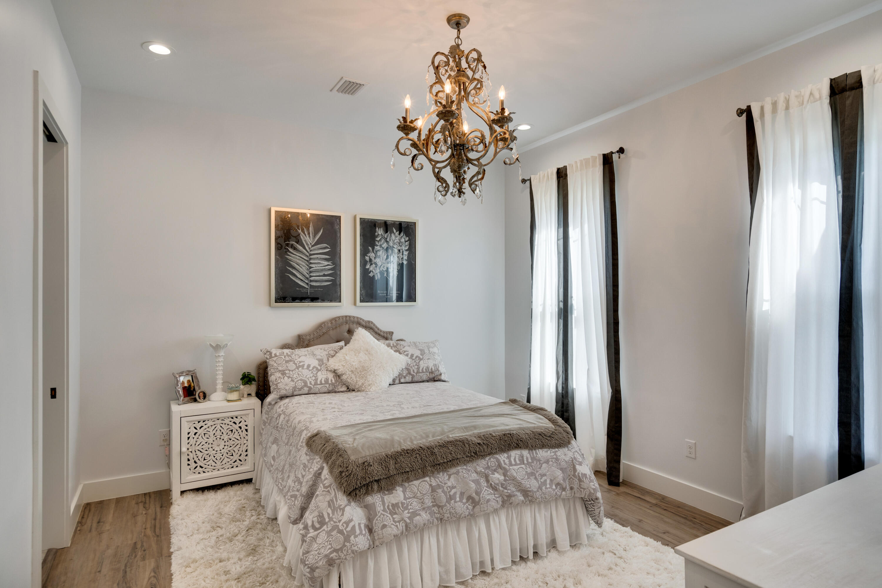 334 Driftwood Point Road Santa Rosa Beach, FL 32459 - Photo 35 of 50 a bedroom with a large bed and a chandelier