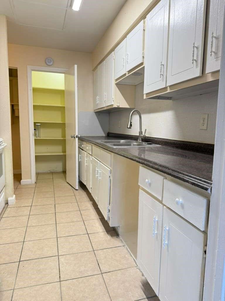 7318 Boone Road, Unit B Houston, TX 77072 - Photo 17 of 23 a kitchen with a cabinets and window