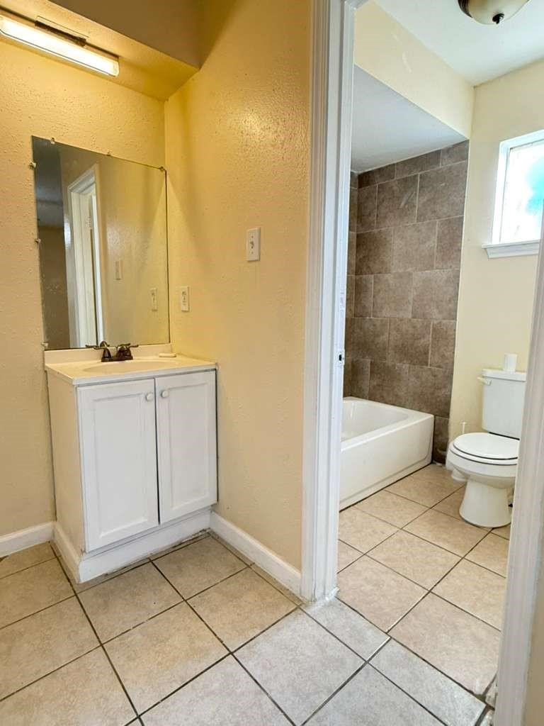 7318 Boone Road, Unit B Houston, TX 77072 - Photo 4 of 23 a bathroom with a sink a toilet and shower