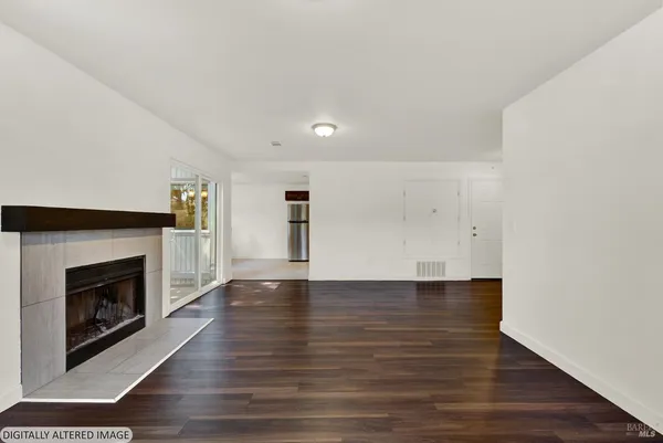 a large kitchen with granite countertop a stove a sink and a refrigerator