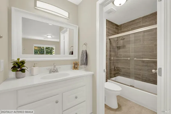 a bathroom with a sink mirror toilet and bathtub
