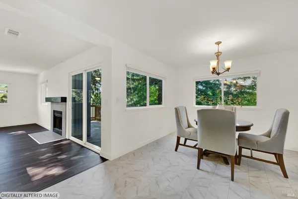 a dining room with furniture and chandelier kitchen view
