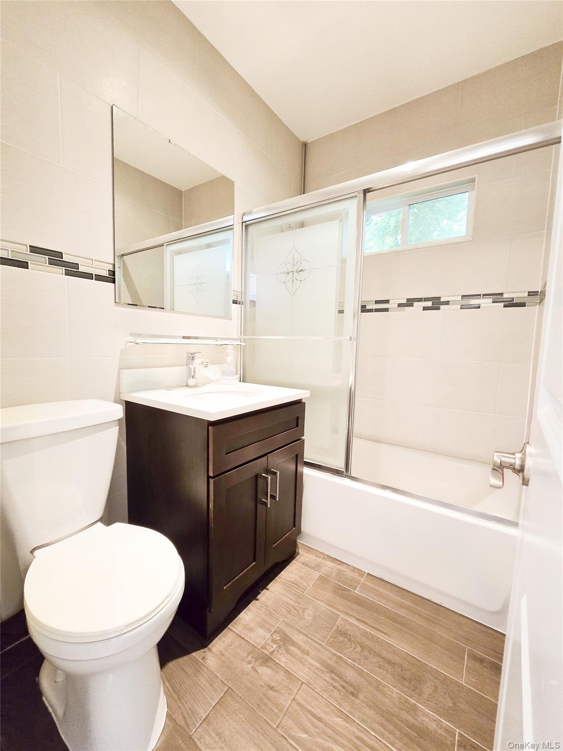 249 Cold Spring Road Syosset, NY 11791 - Photo 20 of 28 a bathroom with a sink vanity mirror and toilet