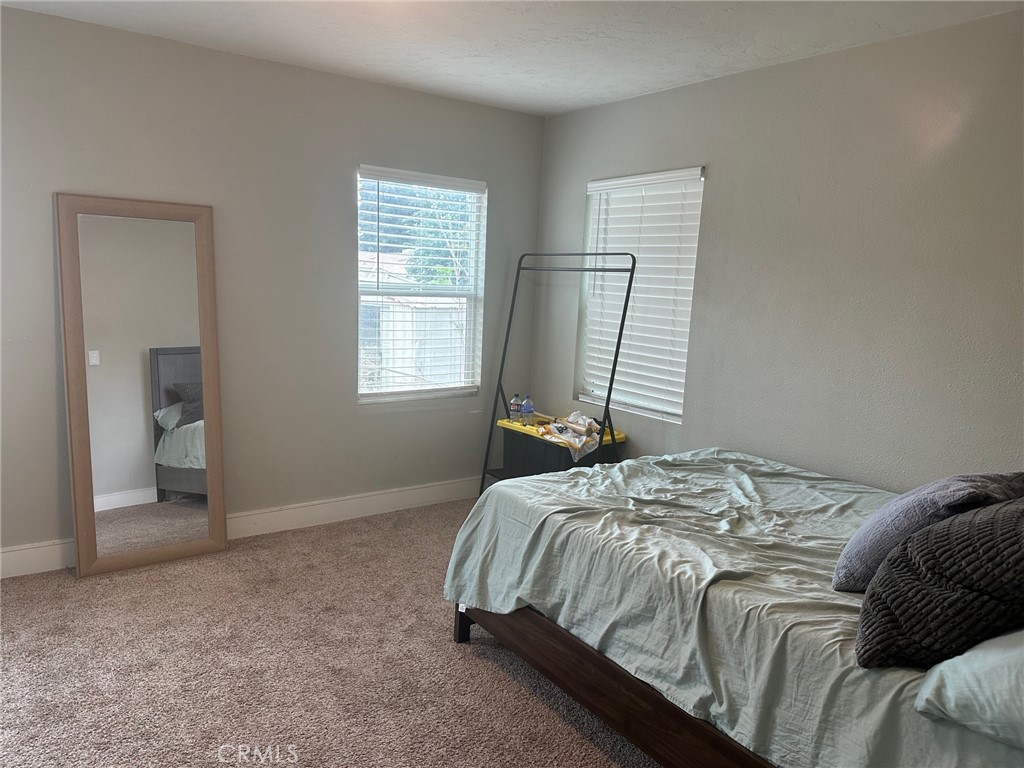 310 Santa Rita Place Banning, CA 92220 - Photo 15 of 27 a bedroom with a bed and a window