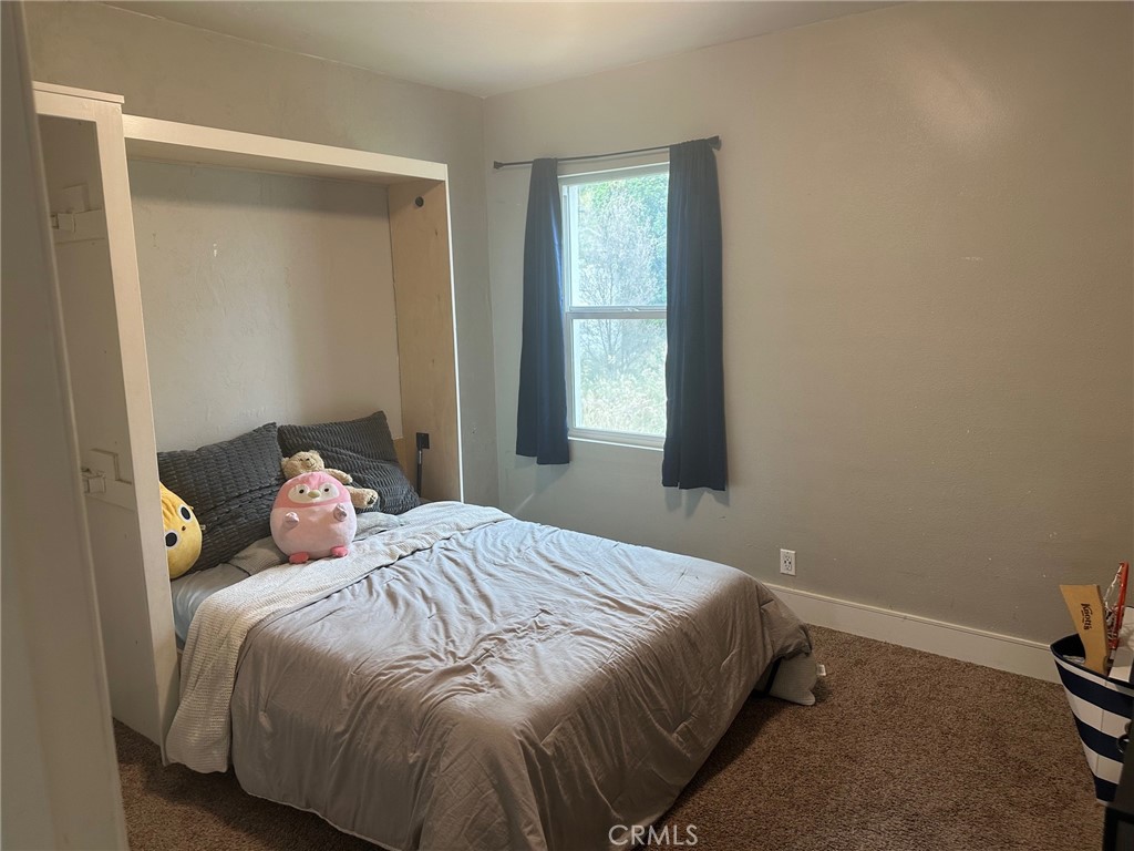 310 Santa Rita Place Banning, CA 92220 - Photo 18 of 27 a bedroom with a bed and a window