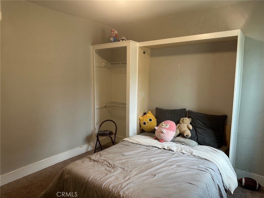 310 Santa Rita Place Banning, CA 92220 - Photo 19 of 27 a bedroom with a bed and a window