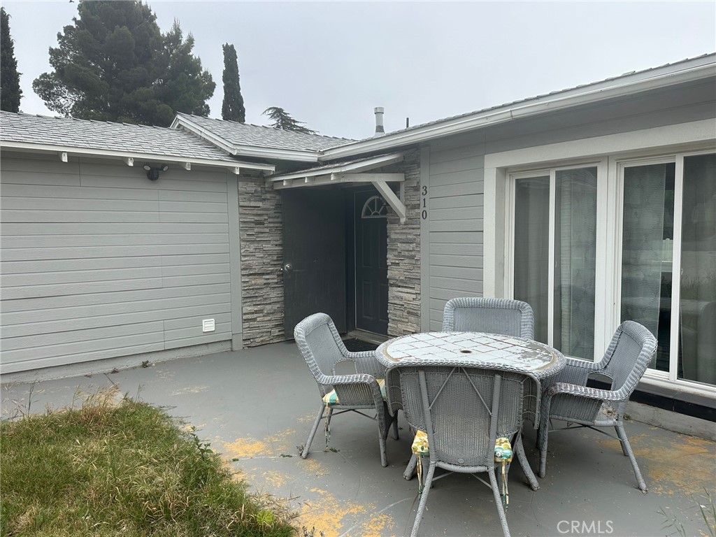 310 Santa Rita Place Banning, CA 92220 - Photo 2 of 27 a patio with table and chairs