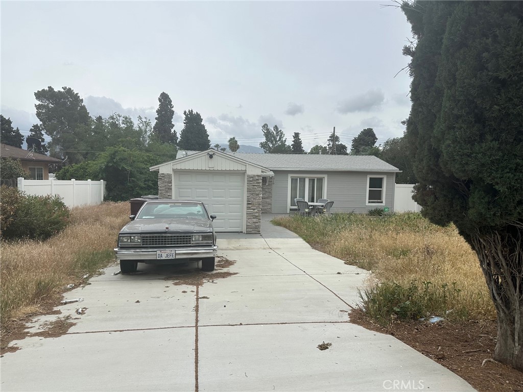 310 Santa Rita Place Banning, CA 92220 - Photo 3 of 27 a car parked in front of white house