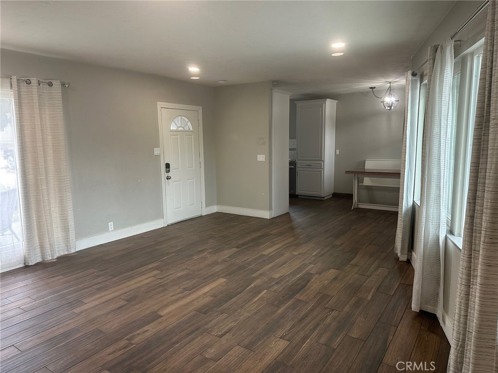 310 Santa Rita Place Banning, CA 92220 - Photo 8 of 27 a view of a big room with wooden floor and a bathroom