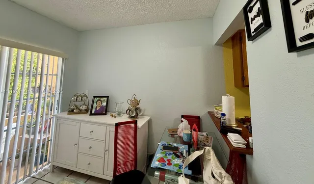 a view of a workspace with furniture and closet