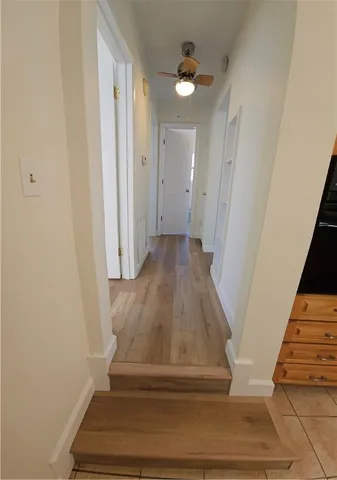 a view of entryway and hall with wooden floor