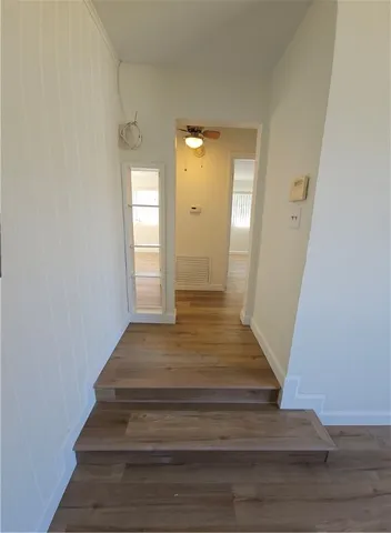 a view of a hallway view with wooden floor and staircase
