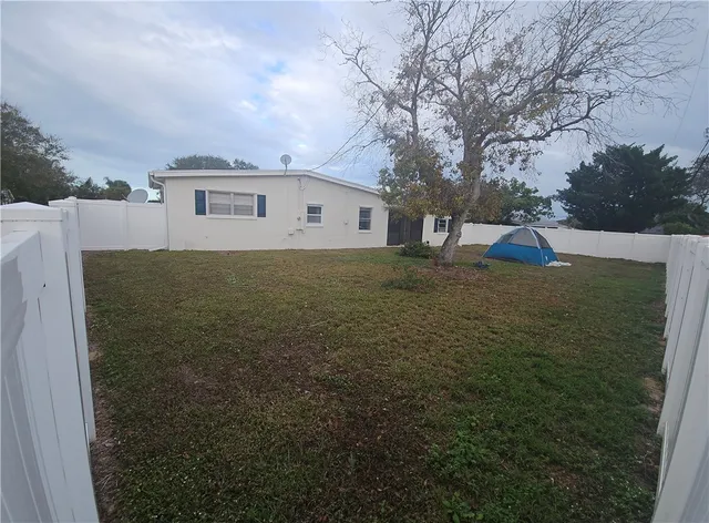 a front view of a house with swimming pool and sitting area