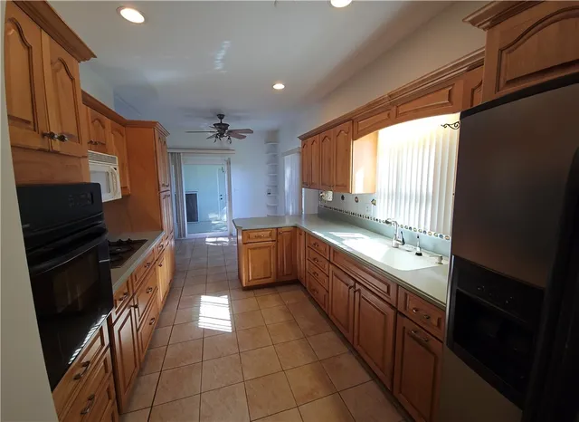 a kitchen with stainless steel appliances granite countertop a sink and a stove
