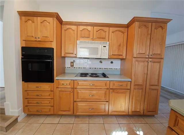 a kitchen with stainless steel appliances granite countertop a refrigerator and cabinets