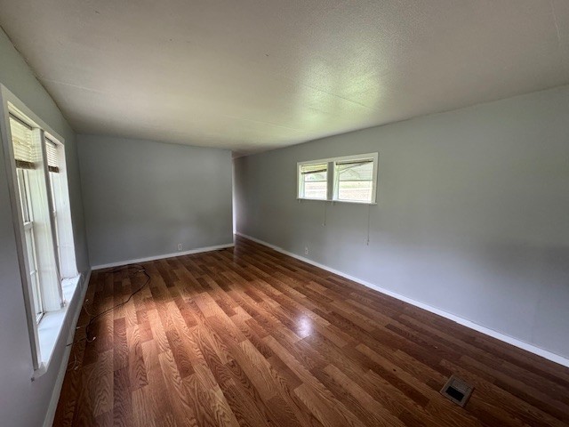 301 Eastbrook Road Estill Springs, TN 37330 - Photo 4 of 7 an empty room with wooden floor and windows