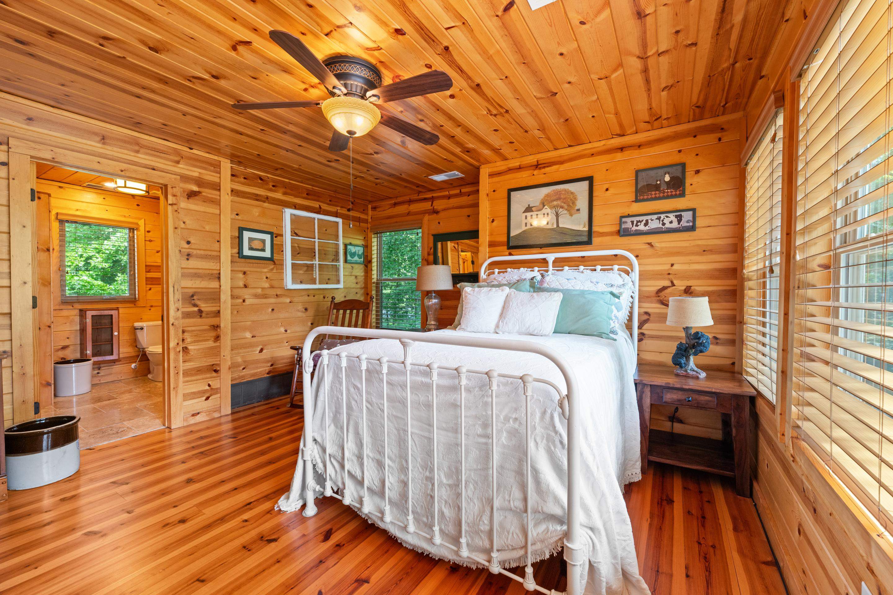 950 Cherry Road Eads, TN 38028 - Photo 15 of 30 Wood-paneled room featuring a ceiling fan with integrated lighting, wood-finish flooring, and a large window with horizontal blinds