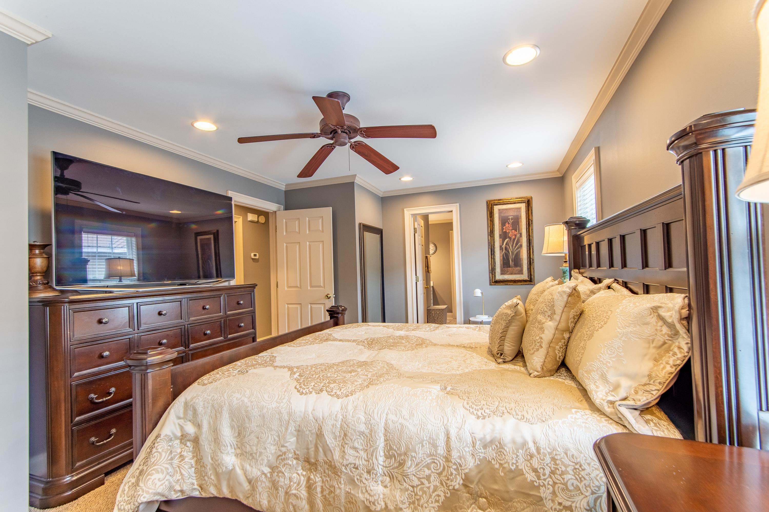 14 Cumberland Circle Iuka, MS 38852 - Photo 11 of 25 a bedroom with a large bed and a flat tv screen on a dresser