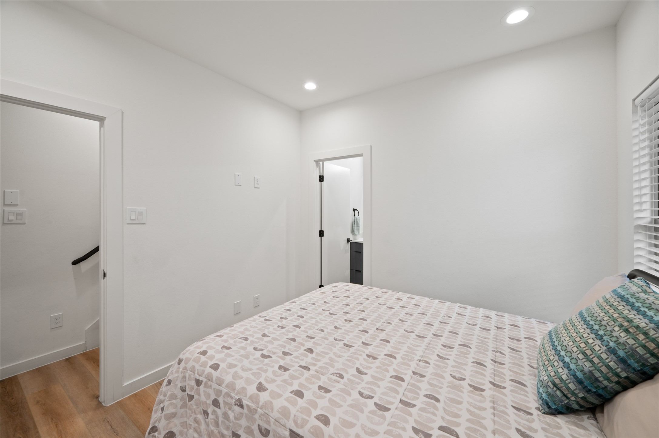 6742 Peerless Street, Unit B Houston, TX 77021 - Photo 8 of 30 a bedroom with a bed and wooden floor