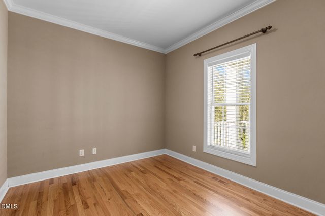 a kitchen with stainless steel appliances granite countertop a sink a stove a refrigerator cabinets and wooden floor