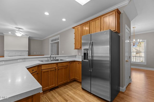 a kitchen with granite countertop wooden cabinets and a stove top oven