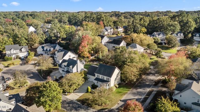 a dining room with furniture a chandelier and wooden floor