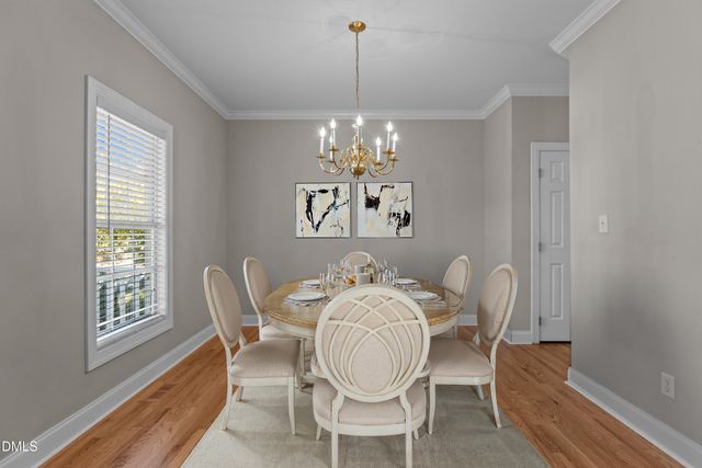 a view of a room with wooden floor and chandelier
