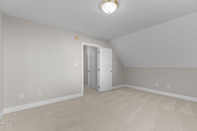 a view of a house with backyard and a tree