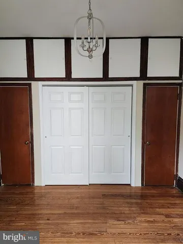 a view of a room with wooden floor