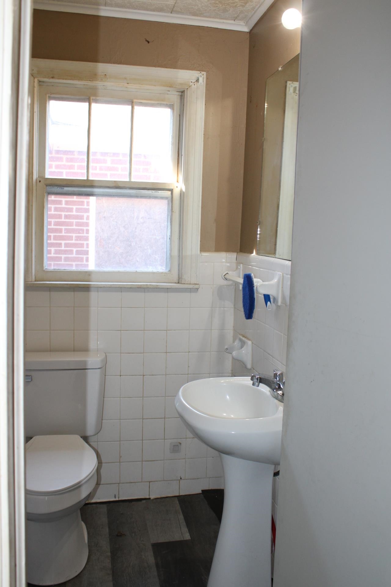 1027 Lynn School Road Ripley, TN 38063 - Photo 15 of 26 a bathroom with a sink a toilet and a mirror