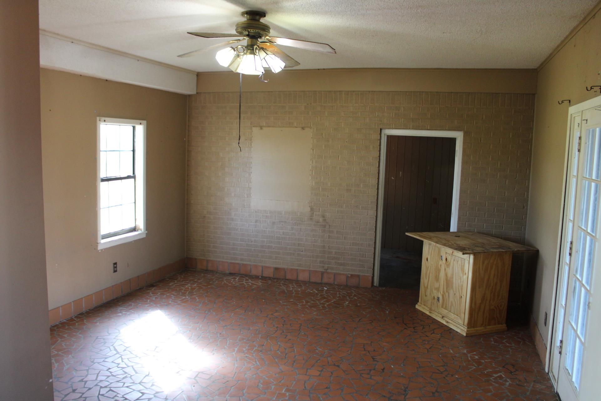 1027 Lynn School Road Ripley, TN 38063 - Photo 21 of 26 en empty room with windows and chandelier fan