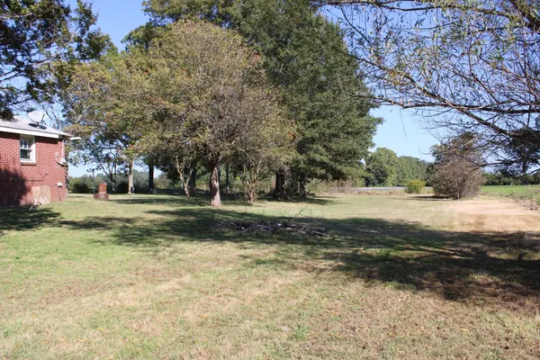a front view of house with yard and trees