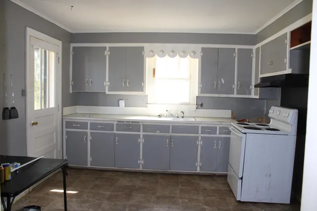 a kitchen with a stove and a sink